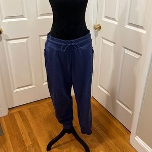 Woman’s, size L, blue Reebok jogging pants. Zip up pockets and squared ankles.